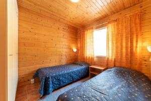 Letto o letti in una camera di Lapin Lumilomat