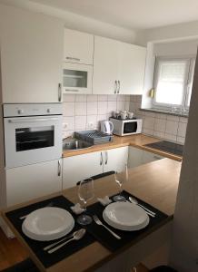 a kitchen with two white plates on a counter at Apartman Lana in Gospić