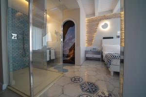 a bathroom with a shower and a bed in a room at Franco's House Tropea in Tropea