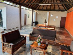 a patio with couches and a table and a couch at Bungalows La Perla Playa Azul in Playa Azul