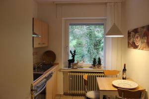 a small kitchen with a table and a window at Ferienapartment Helling in Bad Sobernheim