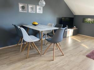 a dining room with a table and chairs at Dolní Morava - Apartmány in Dolní Morava