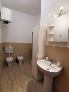 a bathroom with a sink and a toilet at All' Ombra del Faro - Mini Apartments in Taranto