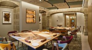 a dining room with long tables and chairs at Palacio de Samaniego in Samaniego