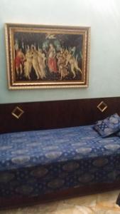 a bedroom with a painting on the wall above a bed at Hotel Abaco in Florence