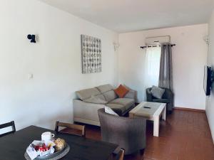 a living room with a couch and a table at LES JARDINS DU FLAMBOYANT in Ziguinchor