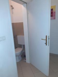 an open door to a bathroom with a toilet at Apartment Dahlia Vienna in Vienna