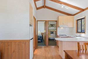 a kitchen with wooden cabinets and a counter top at Discovery Parks - Whyalla Foreshore in Whyalla