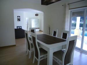 a white table and chairs in a living room at Casa São Bartolomeu - 5 Quartos com Piscina in São Bartolomeu