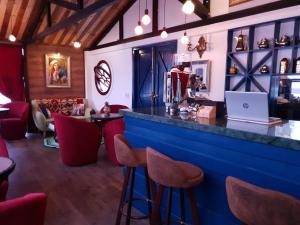 a bar with red chairs and a laptop on the counter at Doc May Boutique Villa in Da Lat