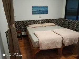 a small bedroom with a bed at SKB Mansion close to MRT in Hua mark in Bangkok