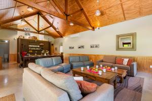 a large living room with couches and a table at The Red Barn - Lake Okareka Holiday Home in Rotokawa