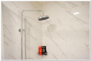 a shower with a shower head in a bathroom at RedDoorz Plus @ Madukoro Raya Semarang in Kalibanteng-lor