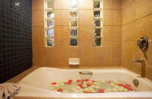 a bath tub filled with lots of sprinkles at Woraburi Phuket Resort & Spa - SHA Plus in Karon Beach