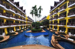 a hotel with a pool in the middle of a resort at Woraburi Phuket Resort & Spa - SHA Plus in Karon Beach