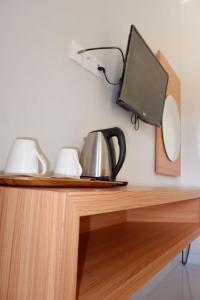 a wooden desk with a tv on top of it at Pemondokan Pratama in Nusa Dua +11 photos