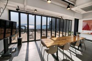 a large room with a wooden table and chairs at Mipo Oceanside Hotel in Busan