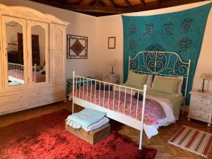 a bedroom with a canopy bed and a mirror at Ecoartejeda Casita original in Tejeda