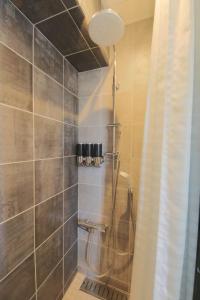 a shower in a bathroom with a shower curtain at さくらや in Okinawa City