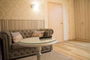 a living room with a couch and a table at Hotel "Ussuriysk" in Ussuriysk
