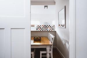 a kitchen with a table and chairs in a room at Station Master's House in Castlemaine