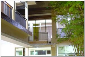 a building with balconies on the side of it at RedDoorz Syariah at Omah Sawah in Balong