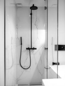 a shower with a shower head in a bathroom at Maison Bellevue in Saint-Tropez