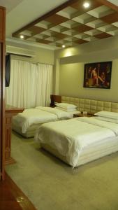 Een bed of bedden in een kamer bij Hotel Aram