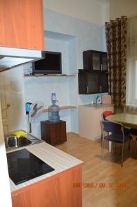 a kitchen with a counter top and a table and a kitchen at гостевой Дом БельвеДеръ in Vyborg