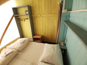 a small room with a bed and a staircase at Sunflower Camping in Novigrad Istria
