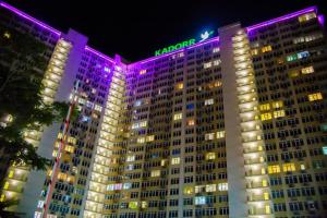 a large building with a hogan sign on it at night at Pearl of Odessa in Odesa