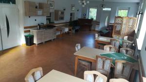 a kitchen and dining room with tables and chairs at Chata Neografia in Martin
