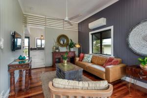 a living room with a couch and a table at 'Kookaburra' at Savannah House in Westcourt