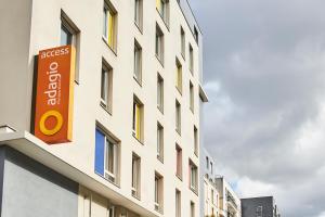 a building with a sign on the side of it at Aparthotel Adagio Access Paris Saint-Denis Pleyel in Saint-Denis
