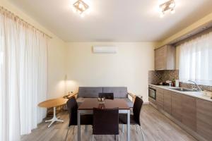 a kitchen and dining room with a table and chairs at Sun, Sand, & Seclusion - Artemis with Private Pool in Finikounta