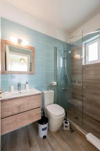 a bathroom with a toilet and a sink and a shower at Sun, Sand, & Seclusion - Artemis with Private Pool in Finikounta +13 photos