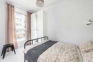 biała sypialnia z łóżkiem i oknem w obiekcie SuperApart Stalowa 39 Modern Unit with Kitchen & Wifi w Warszawie