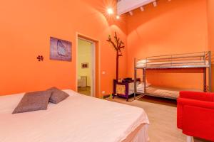 a bedroom with a bunk bed and a red chair at Colleincanto Appartamento Vittorio in Gavardo +22 photos
