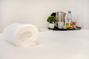 a glass of water sitting on a counter with a coffee maker at Classico Guesthouse in Vila Nova de Gaia