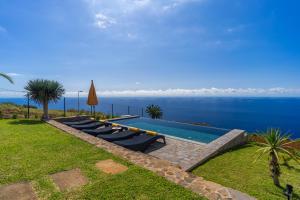 a swimming pool with a view of the water at Villa Fauna - Nature & Tranquility - Heated pool optional in Prazeres