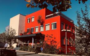 a red building on the side of a street at Villa Rambouillet in Rambouillet