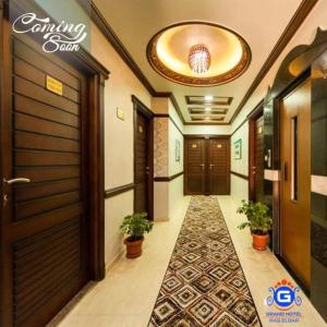 a hallway with doors and potted plants in a building at Grand Hotel Ras Elbar in Ras El Bar