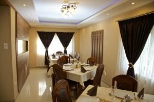 a dining room with tables and chairs and a chandelier at Becsi Szelet in Miercurea-Ciuc