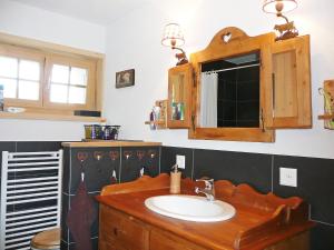 a bathroom with a sink and a mirror at Chalet Chalet La Poya by Interhome in Moleson