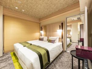 Hotel Musse Kyoto Shijo Kawaramachi Meitetsu客房内的一张或多张床位