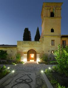 a large stone building with a clock on it at Parador de Granada in Granada