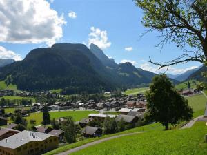 a small town in a valley with mountains in the background at Apartment Meielblick by Interhome in Gstaad