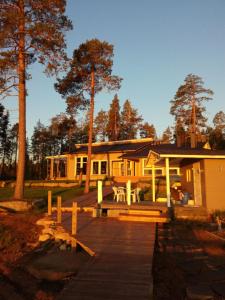 a house with a wooden dock in front of it at Chalet Norva in Rovaniemi