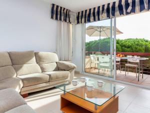 a living room with a couch and a glass table at Holiday Home Wouters by Interhome in El Puerto