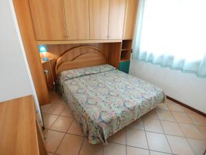 a small bedroom with a bed in a room at Apartment Mediterraneo-3 by Interhome in Rosapineta +15 photos